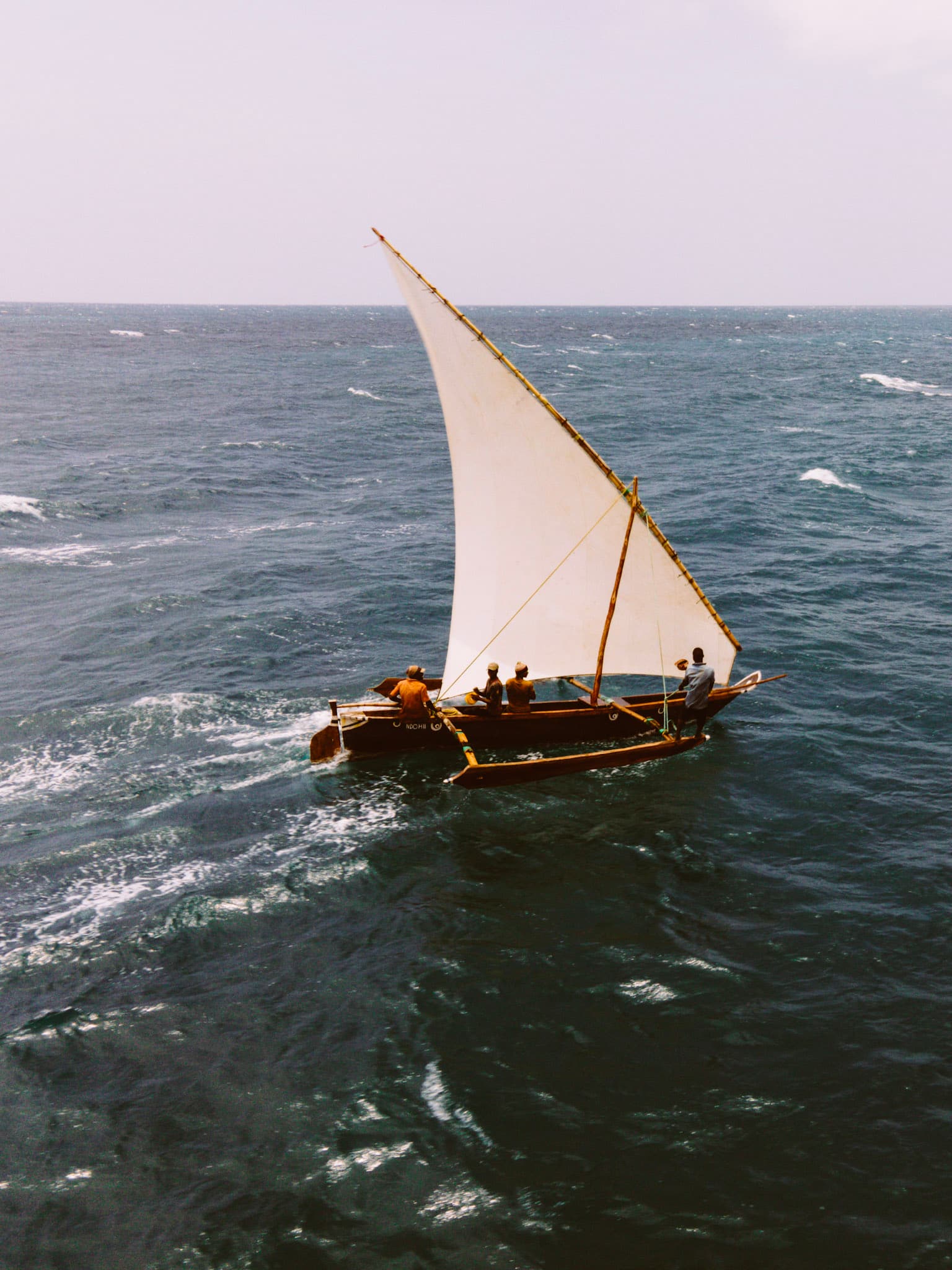 Traditional ngalawa outrigger boat sailing off Zanzibar