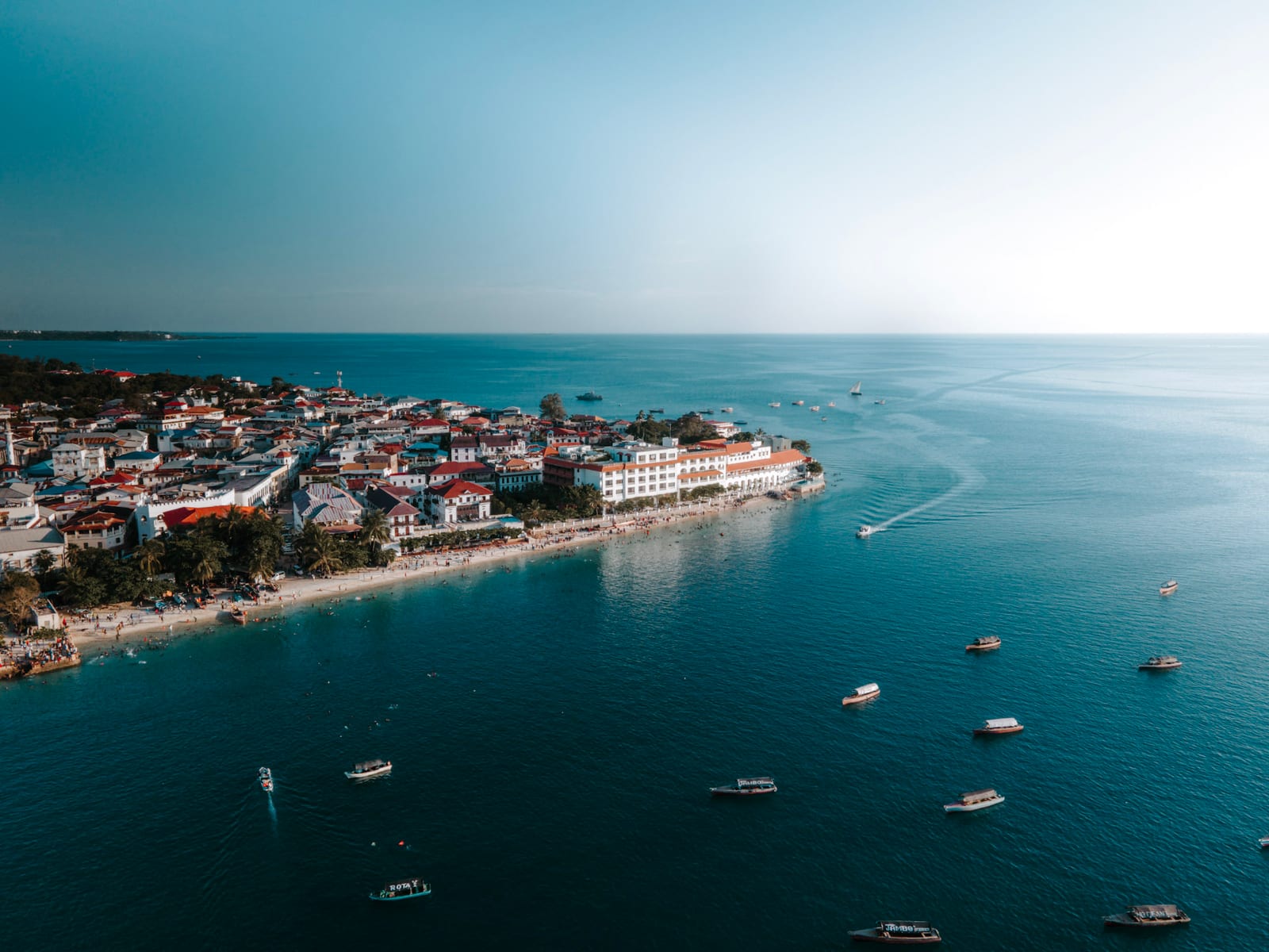 Aerial view of Stone Town's waterfront and rooftops along the Zanzibar coast